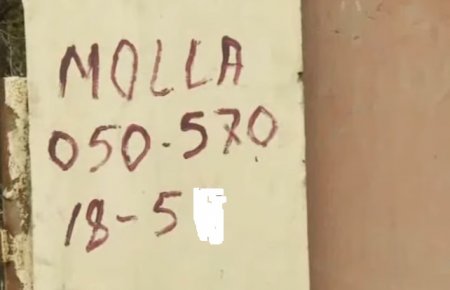 Bakıda molla qəbiristanlığın divarını telefon nömrəsi ilə “bəzəyib”